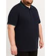 Thumbnail Navy tipped polo shirt shown on model, angled side view.